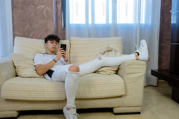 Young man posing on a living room sofa