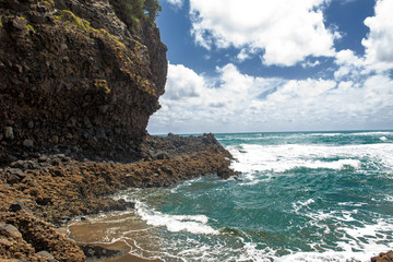 Seascape of a cliff near the ocean under a blue sky - 328672201