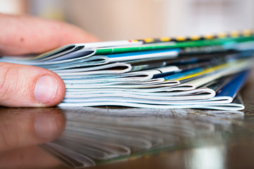 Closeup background of a pile of old magazines with bending pages