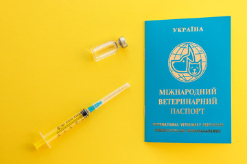 Syringe, glass vial with liquid and ukrainian animal passport for indicating vaccinations and...