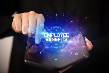 Businessman holding a foldable smartphone with EMPLOYEE BENEFITS inscription, new business concept