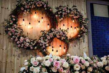 a wreaths of flowers and bulbs on wooden wall.