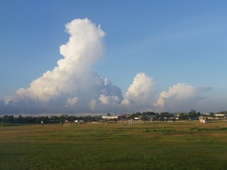Fototapeta na wymiar Gorgeous clouds on villages close ot the Davao International Airport.