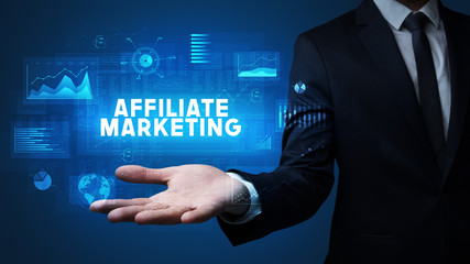 Hand of Businessman holding AFFILIATE MARKETING inscription, business success concept