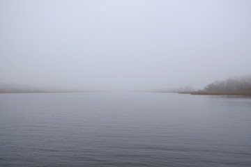 A moody landscape, an empty misty lake - peace and quiet. Kamien Pomorski, Poland