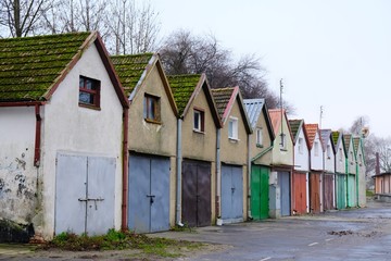 Fototapeta na wymiar Interesting buildings of small colorful houses with garages. Kamien Pomorski, Poland