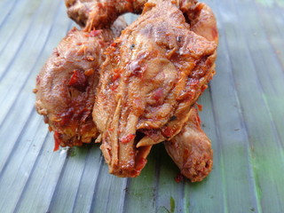 Spicy grilled quail's egg (telur bakar pedas) on banana leaves. Indonesian cuisine street food.