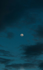 Naklejka na ściany i meble Moon unsigned on a cloudy sky
