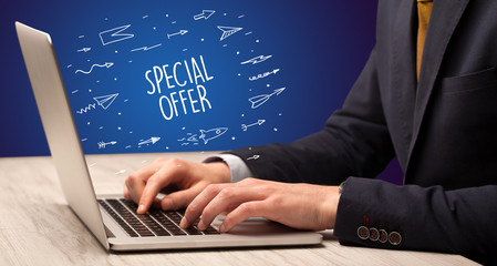 Businessman working on laptop with SPECIAL OFFER inscription, online shopping concept