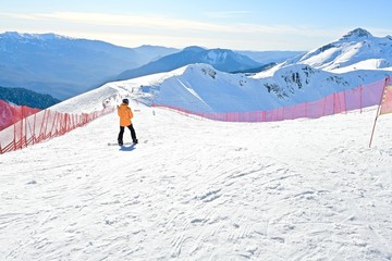 young athlete on a snowboard track at a ski resort
