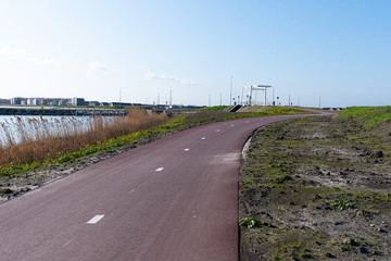 a cycle path with a bridge in the background on a sunny day. In Zeewolde Flevoland. March 7, 2020 the Netherlands.