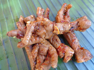 Spicy grilled quail's egg (telur bakar pedas) on banana leaves. Indonesian cuisine street food.