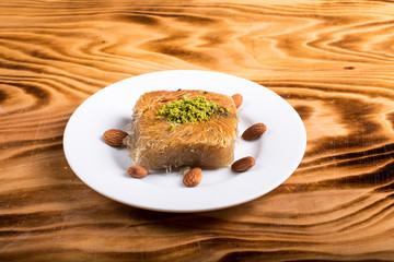 pistachio kadayıf dessert in white plate