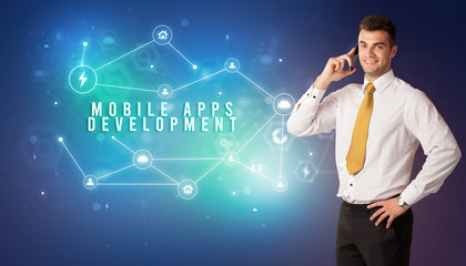 Businessman in front of cloud service icons with MOBILE APPS DEVELOPMENT inscription, modern technology concept