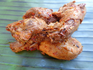 Spicy grilled quail's egg (telur bakar pedas) on banana leaves. Indonesian cuisine street food.