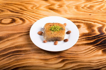 pistachio kadayıf dessert in white plate