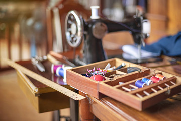sewing tools and reels of color thread on table.