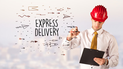 Handsome businessman with helmet drawing EXPRESS DELIVERY inscription, contruction sale concept