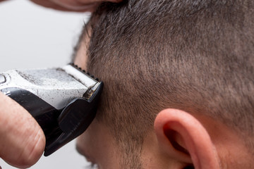 Fototapeta premium Short haircut under the typewriter side view