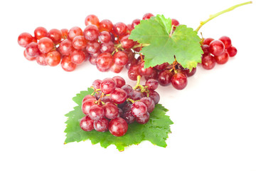 Ripe red grape with leaves isolated on white background
