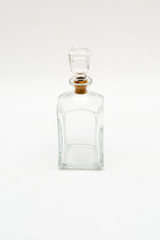 Vintage glass decanter made of transparent glass without a pattern on a white background