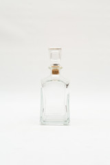 Vintage glass decanter made of transparent glass without a pattern on a white background