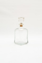 Vintage glass decanter made of transparent glass without a pattern on a white background