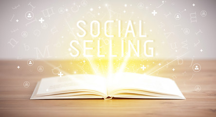 Open book with SOCIAL SELLING inscription, social media concept