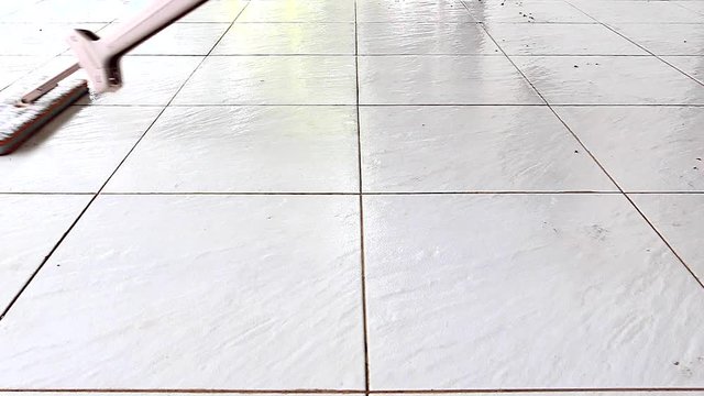 Cleaning the tile floor with a mop