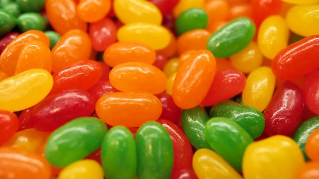 Super close up of a multi-colored dragee. Multicolored candys. Colored easter dragees. Red, green, yellow and orange candys.