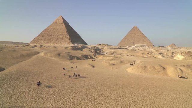 Panoramic view of the Great Pyramid of Giza also known as the Pyramid of Khufu (Cheops) and the Pyramid of Khafre (Chephren) on the Giza Plateau in Cairo, Egypt. 
