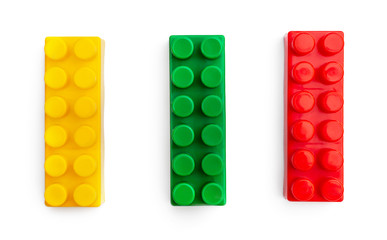Three pieces of toys bricks on white.
