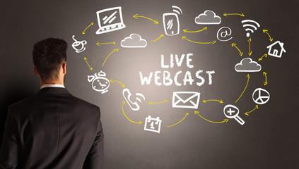 businessman drawing social media icons with LIVE WEBCAST inscription, new media concept