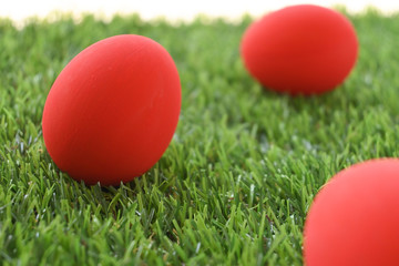red easter egg on lawn green grass artificial, image of morning springtime concept