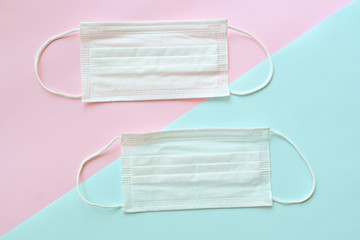 medical hygiene face mask on pink and blue pastel background