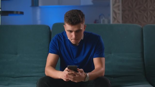 Excited man winner holding using smartphone feeling overjoyed with mobile online bet bid gambling game win, happy guy euphoric looking at cell phone celebrate good news victory success.