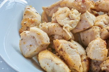 Fried chicken meat in spices on a plate