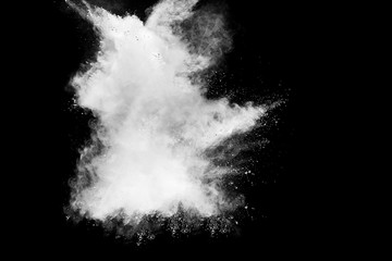 White powder explosion cloud against black background.White dust particles splash.
