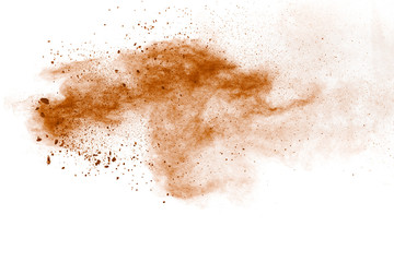 Fototapeta na wymiar Freeze motion of brown dust explosion.Stopping the movement of brown powder.