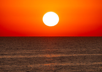 Fototapeta na wymiar big sun over sea sunrise