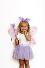 Fairy tale concept. Cute Little blonde girl wearing beautiful princess dress with fairy wings
