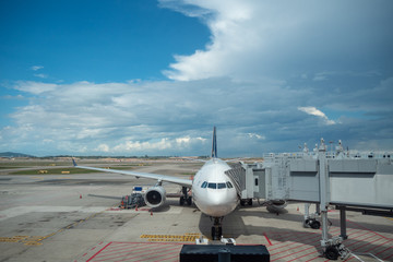 Aircraft dock at terminal for passenger in Zurich Kloten airport on blue sky with cloud background , copy space , Switzerland