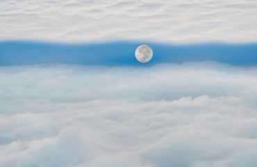 Naklejka na ściany i meble The moon is floating between 2 cloud planes fluffy cloud with blue sky in a morning