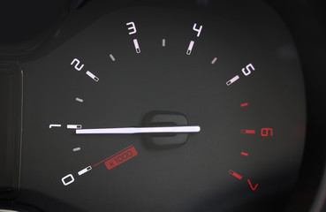 Vehicle tachometer on black background