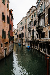 Fototapeta na wymiar View of the rustic architecture of Venice, Italy canal alley 