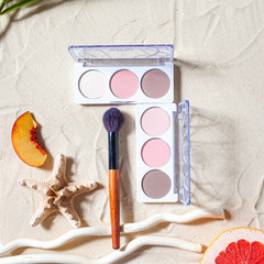 Vacation. A sculpting palette and brush lie on the beach sand, surrounded by vibrant fruits,...