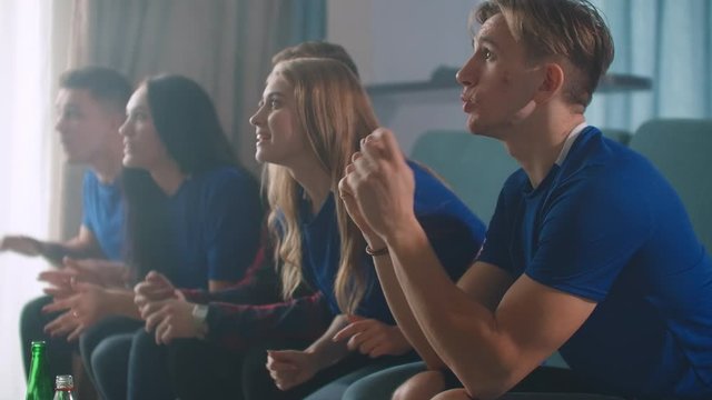 Emotion, fans watching football match on TV with excitement and then rejoice at the victory sitting on couch with