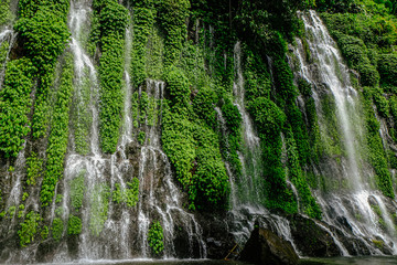 Beautiful and scenic view of Asik-asik Falls in Alamada, Cotabato, Philippines. Water from this waterfalls comes directly from the wall of a towering mountain.