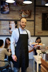 Waiter working in cafeteria