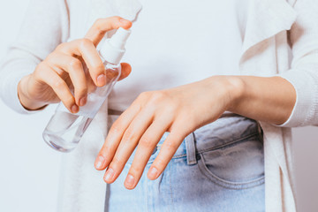 Female hands applying antibacterial disinfectant spray